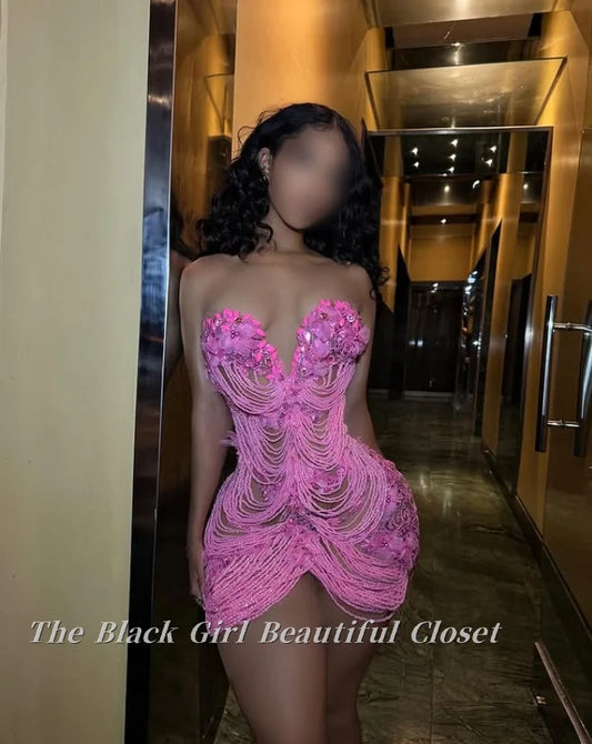 Person wearing a pink beaded dress in a hallway with 'The Black Girl Beautiful Closet' branding.
